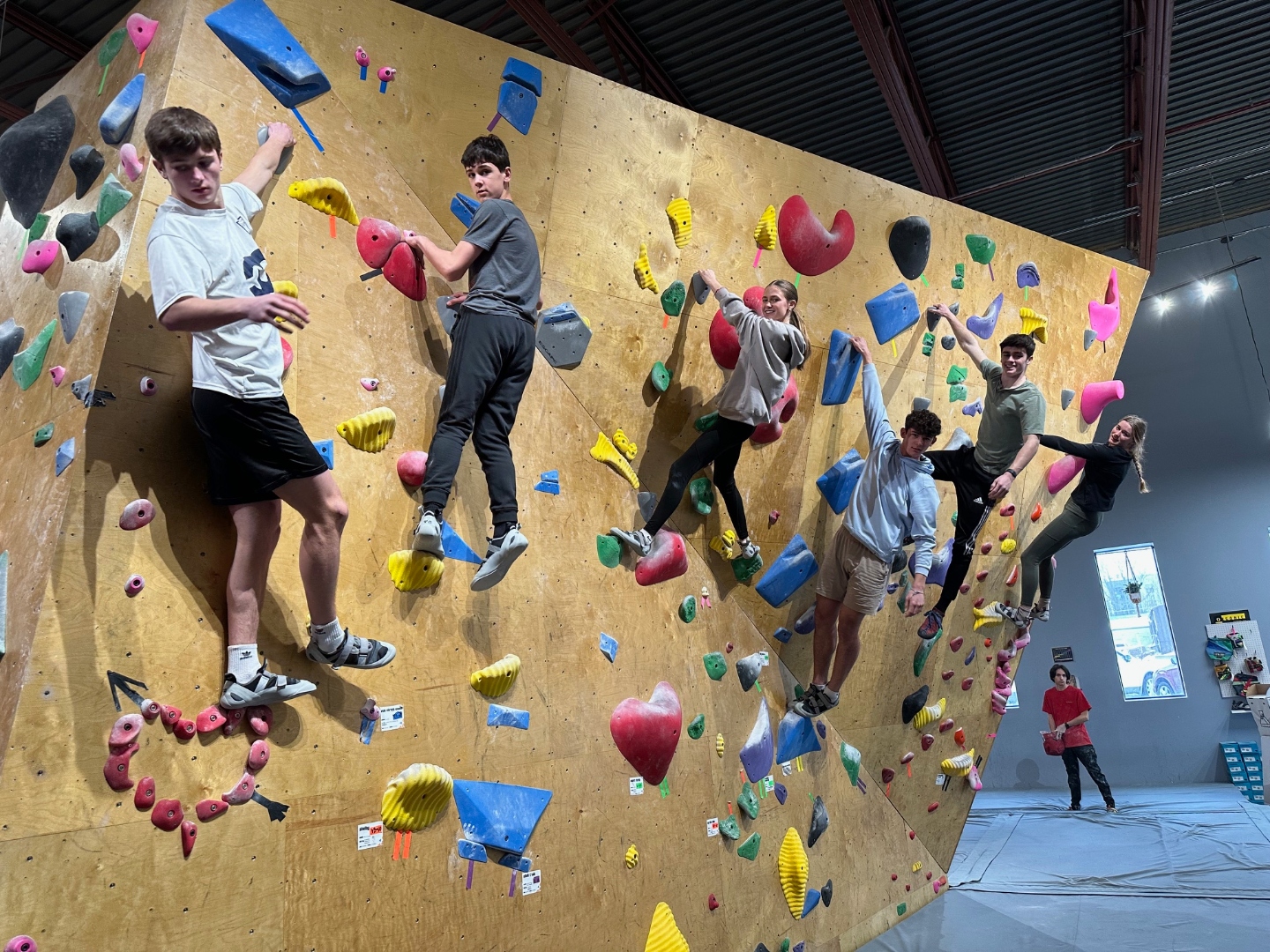 Kids climbing together on a bouldering wall