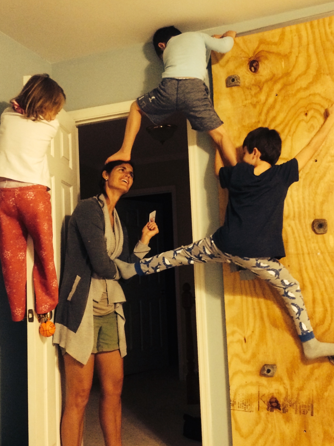 Family climbing on a home climbing wall